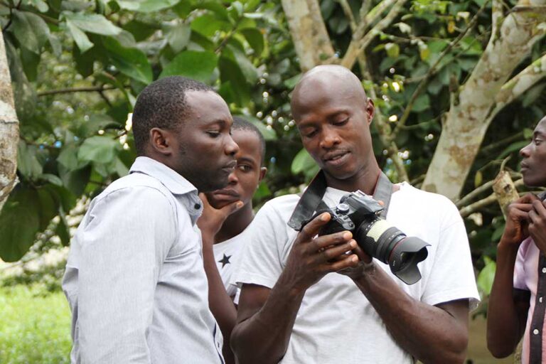 Students learning the setting of the camera