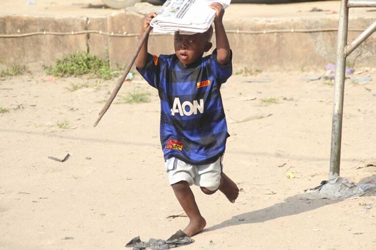 The moment the boy was running home to his parents with their newspaper